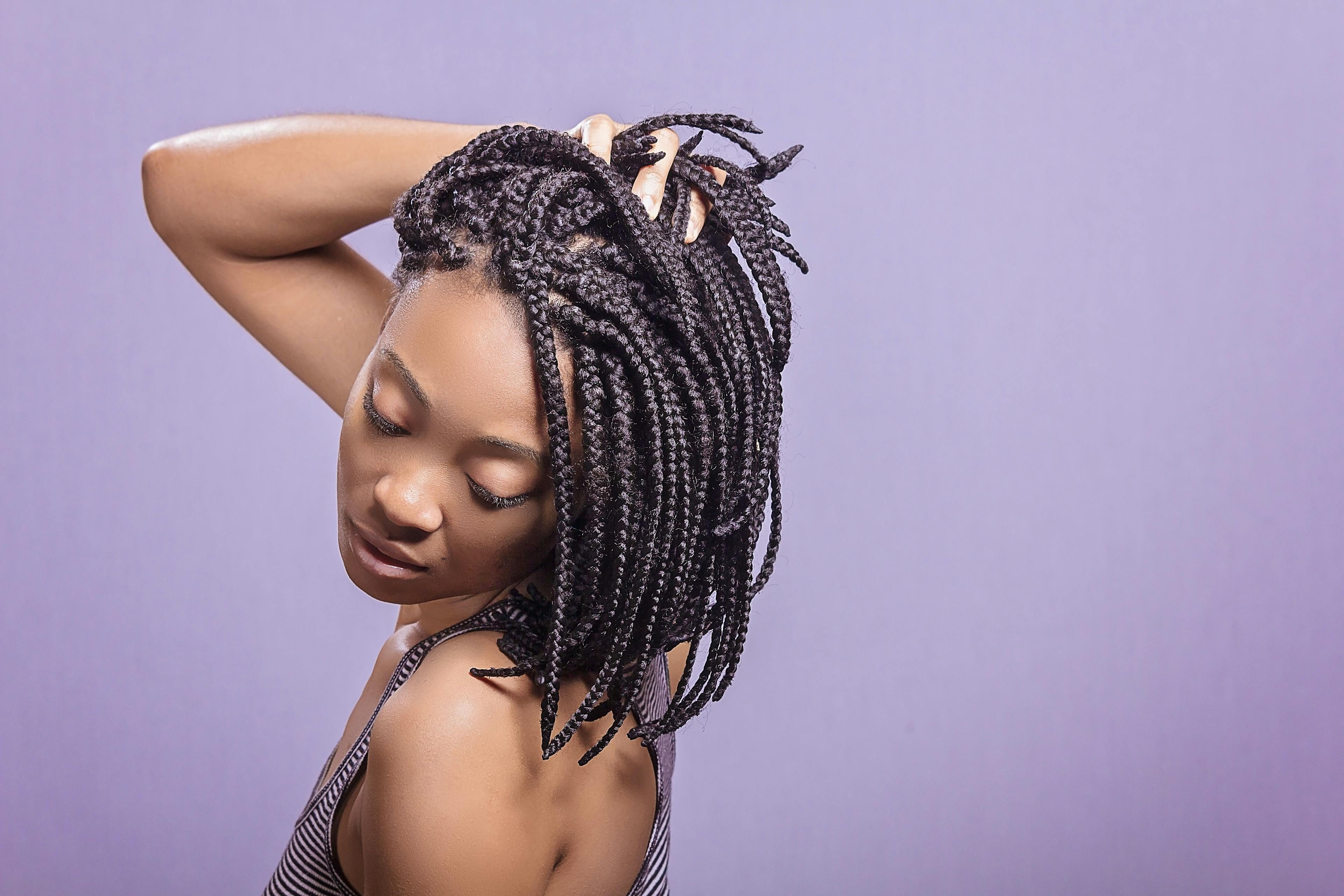 A black woman with braided hair